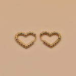 Gold heart huggies hoop earrings with charm design