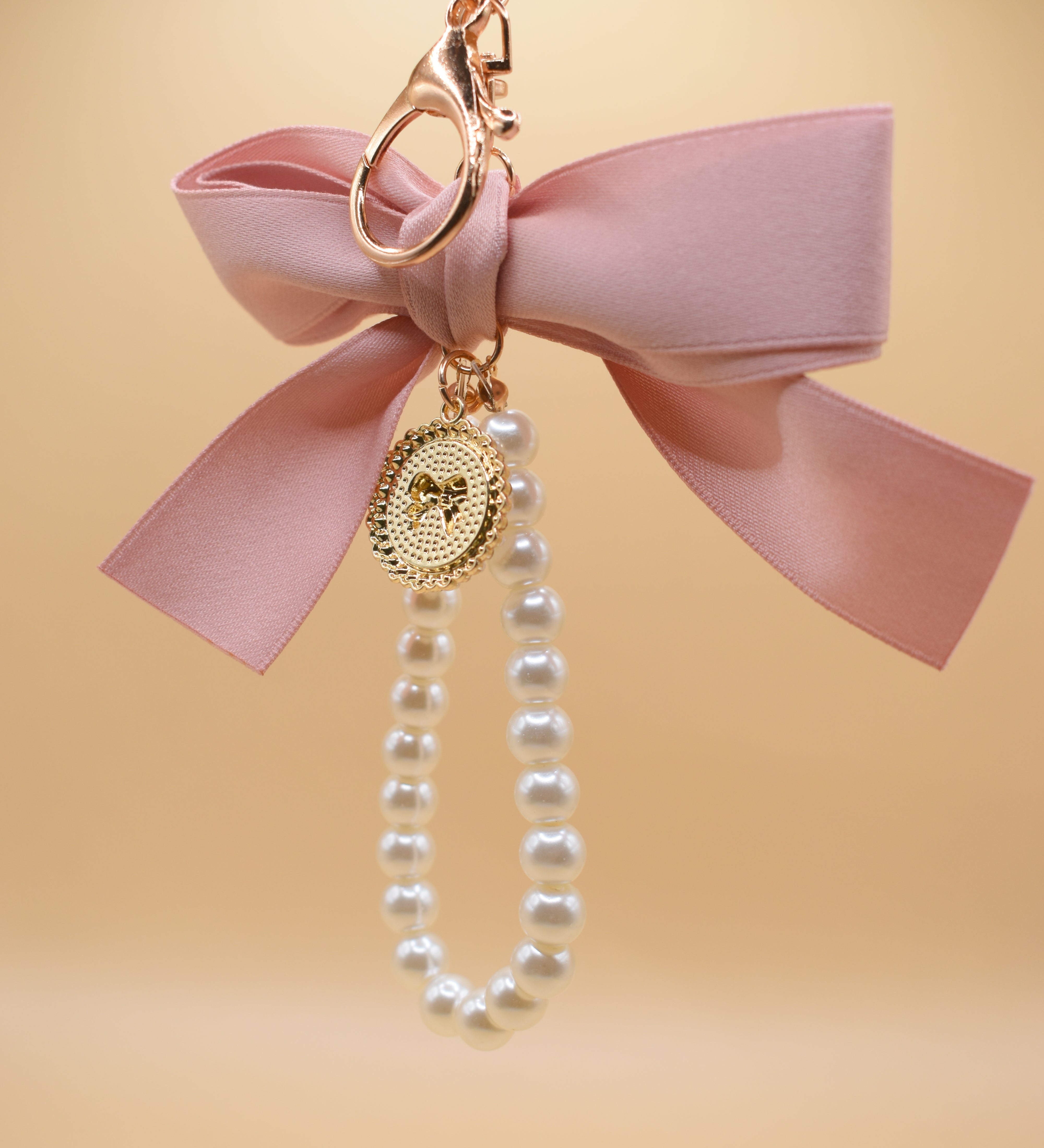Gold bow with pearl bag charm clip accessory