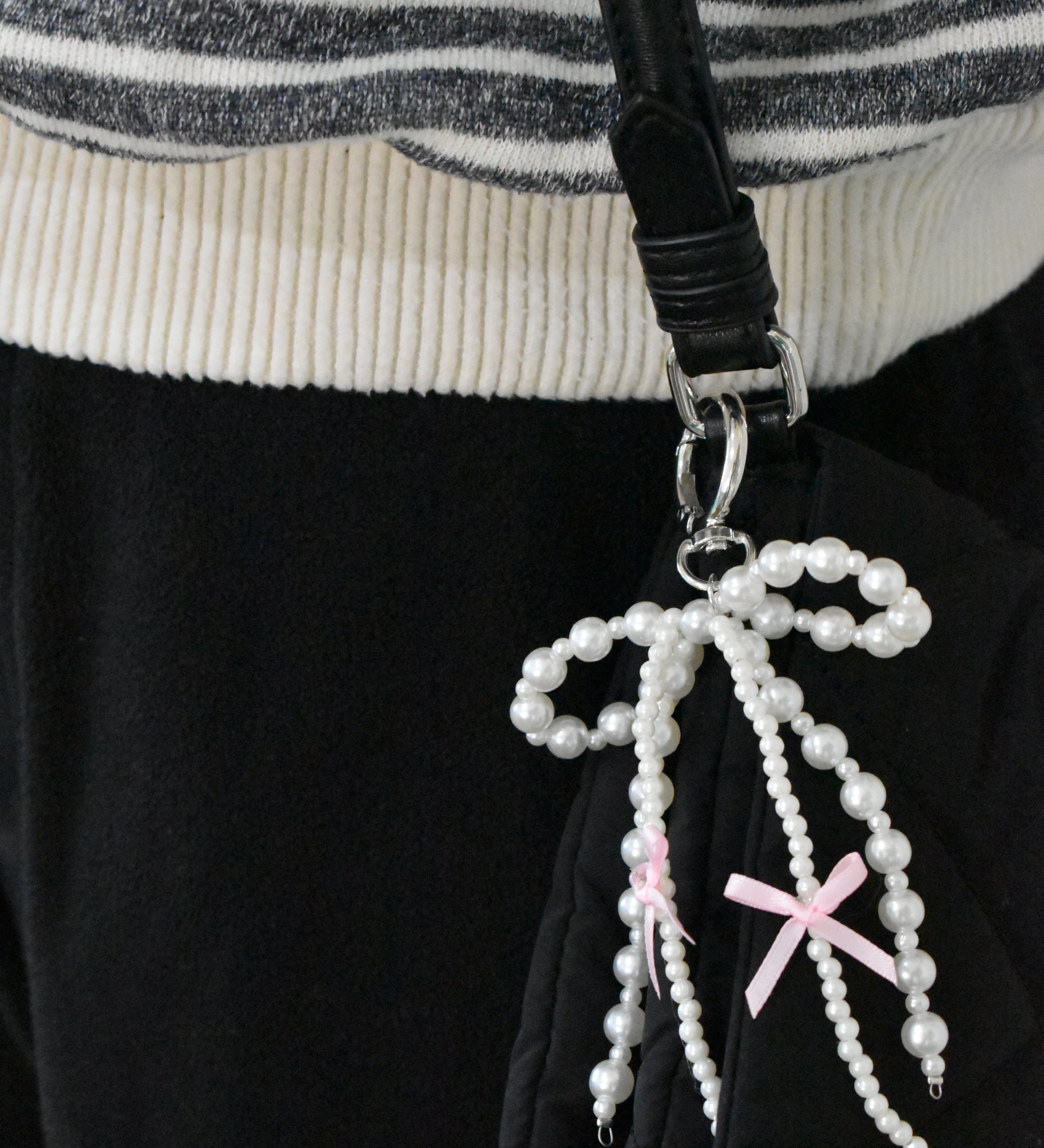 White pearl bow charm attached to gold purse clip