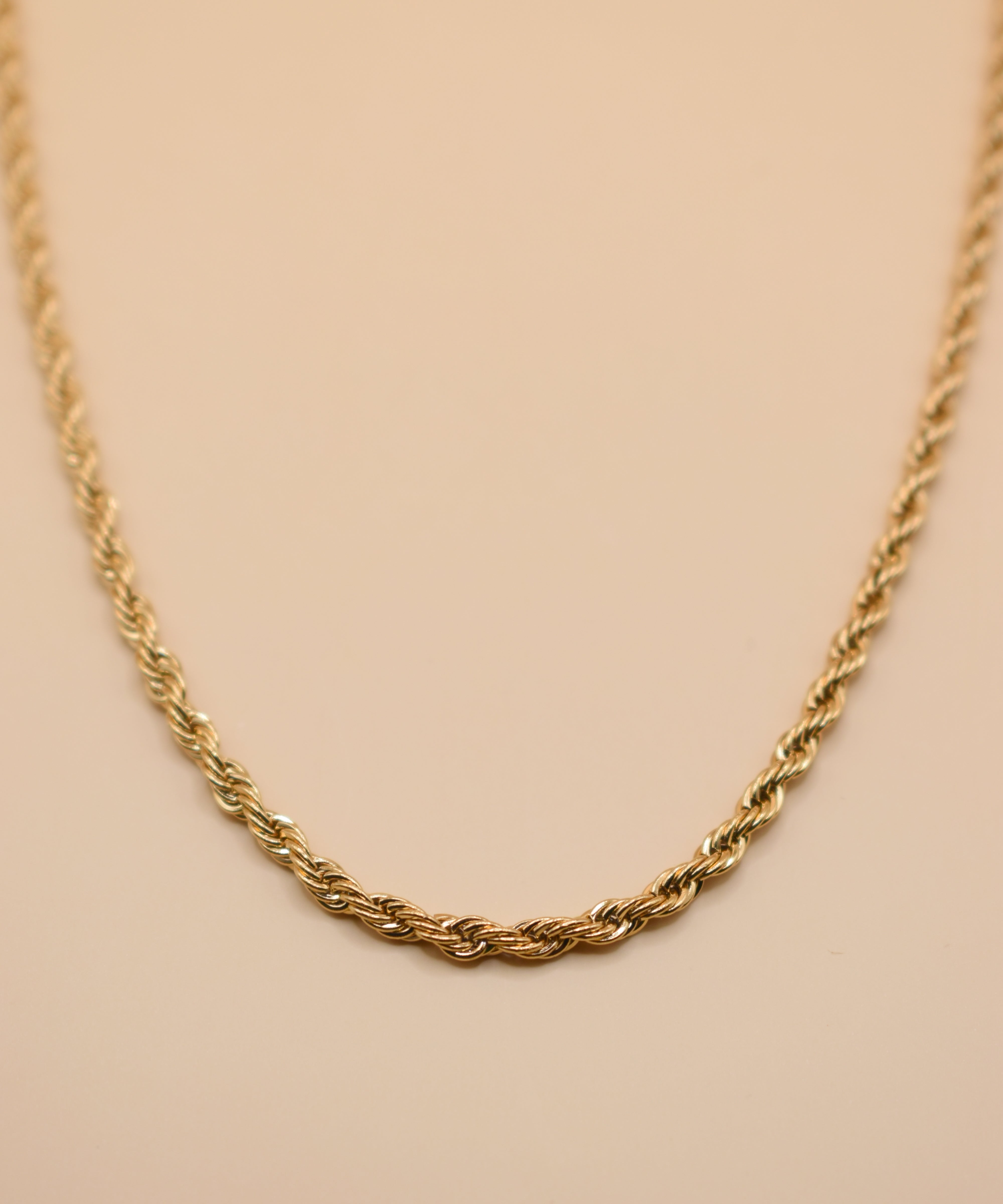 Gold rope necklace with twisted chain design