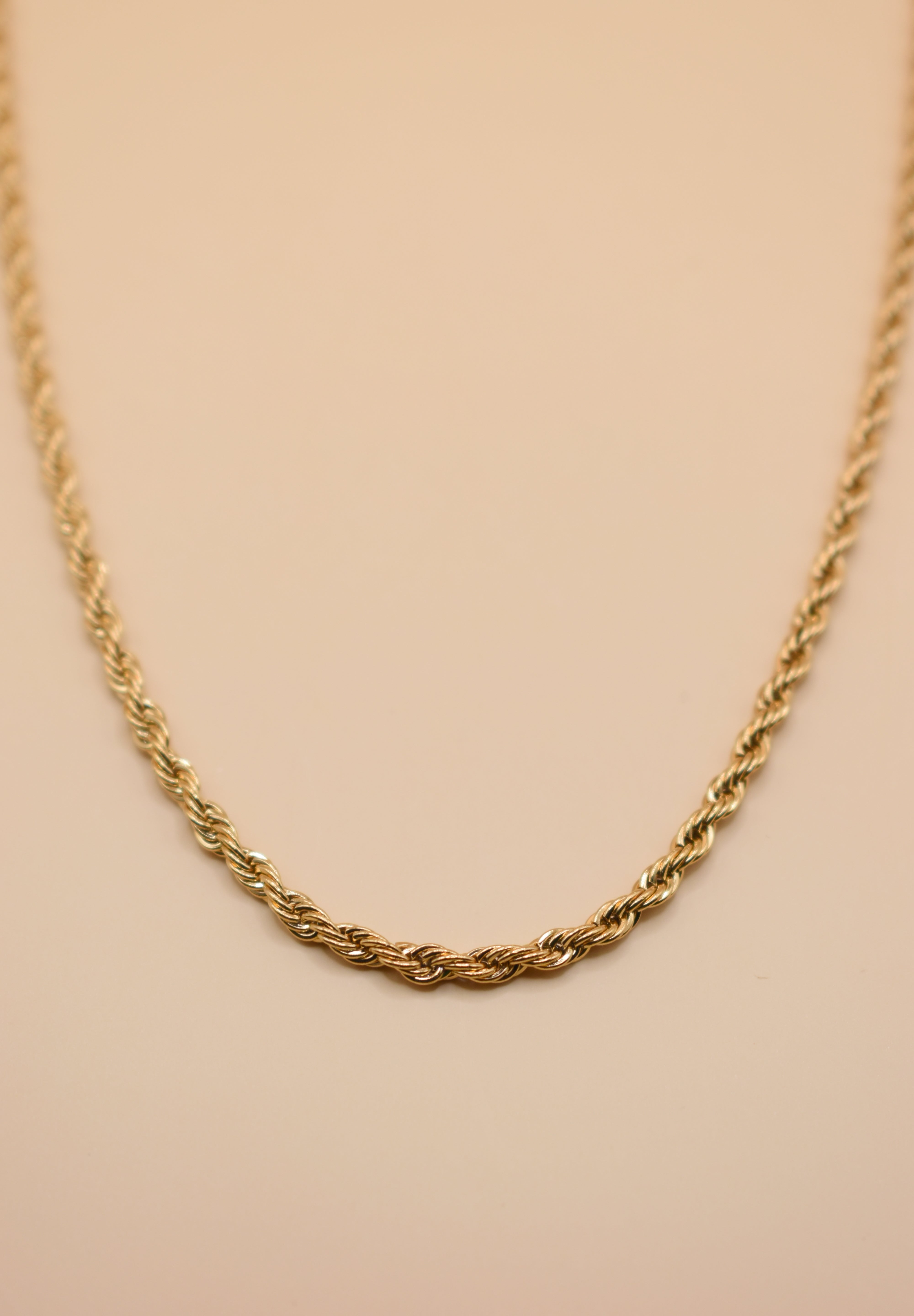 Gold rope necklace with twisted chain design