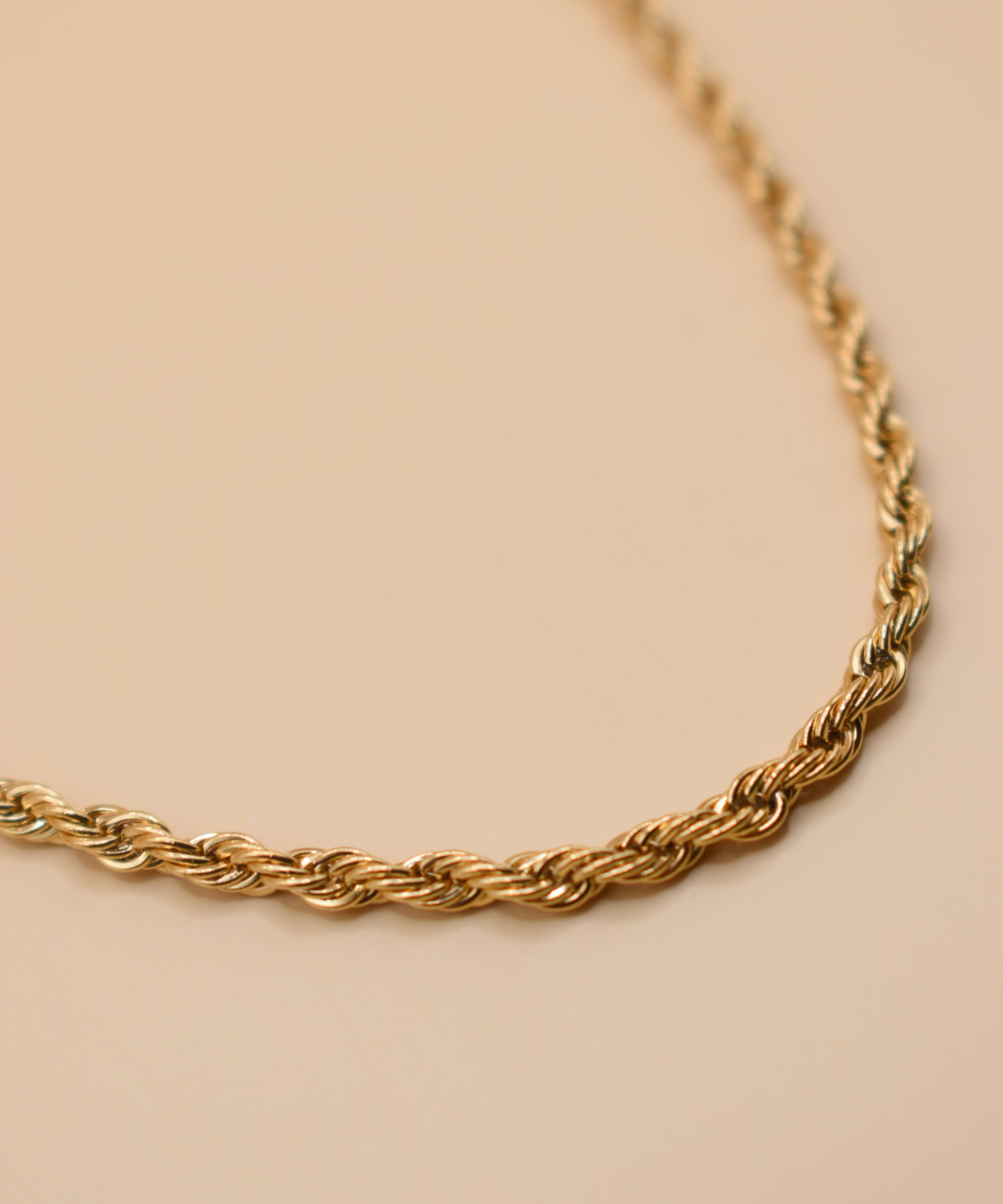 Gold rope necklace with twisted chain design