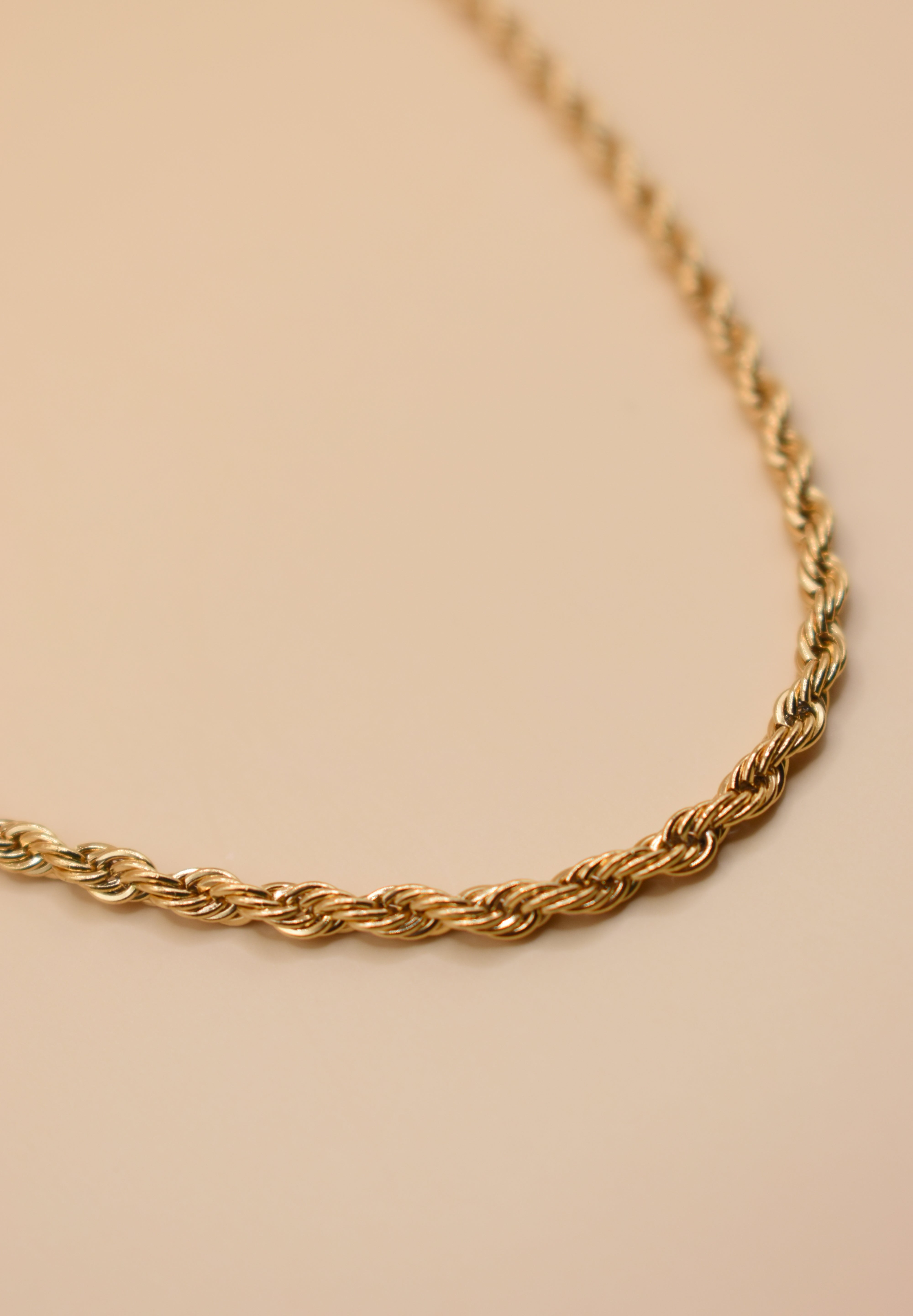 Gold rope necklace with twisted chain design