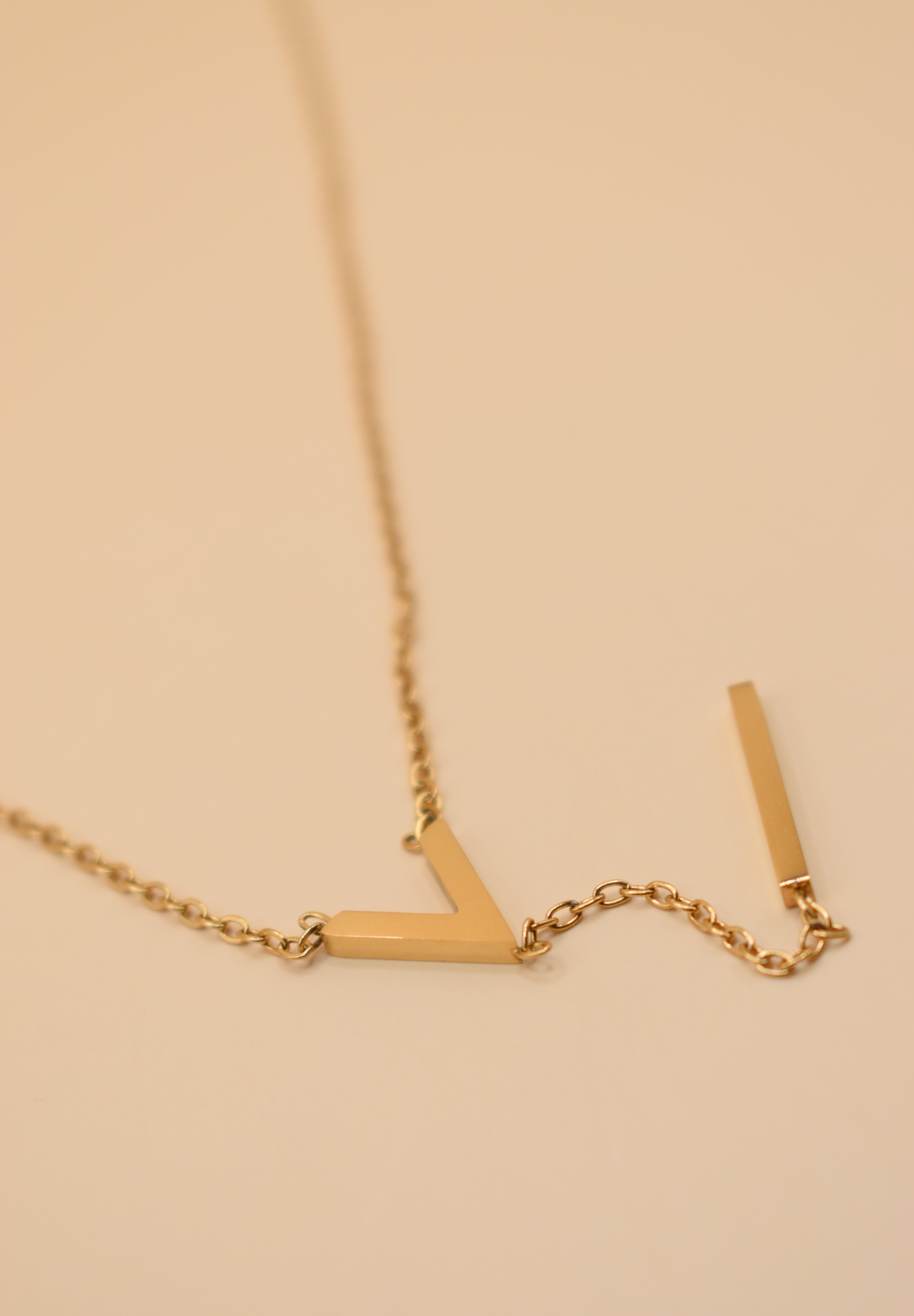Gold pendant drop necklace with minimalist V-shape chain