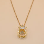 Gold crown necklace with small pendant and thin chain
