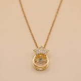 Gold crown necklace with small pendant and thin chain