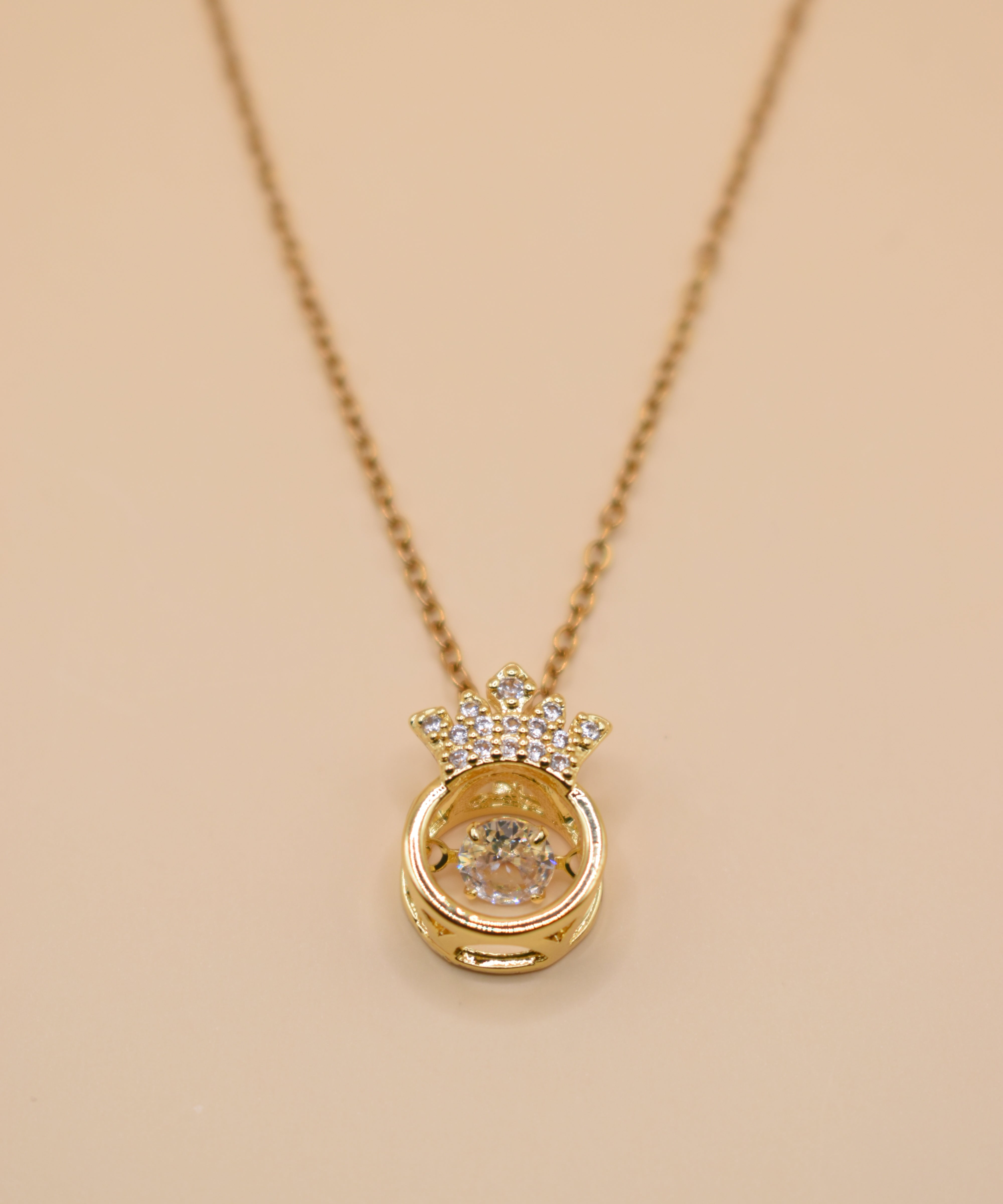 Gold crown necklace with small pendant and thin chain
