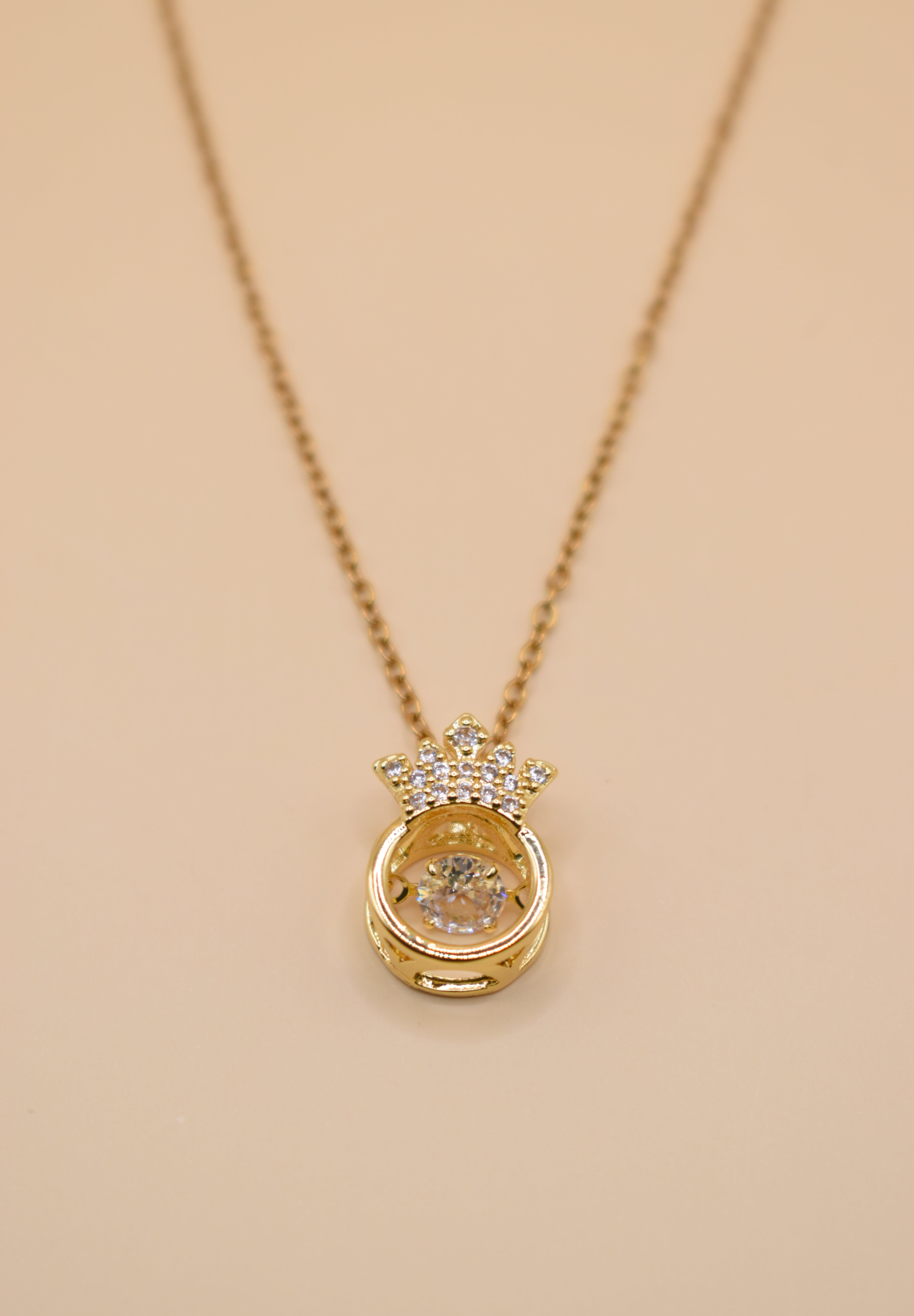 Gold crown necklace with small pendant and thin chain