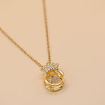 Gold crown necklace with small pendant and thin chain