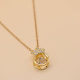Gold crown necklace with small pendant and thin chain