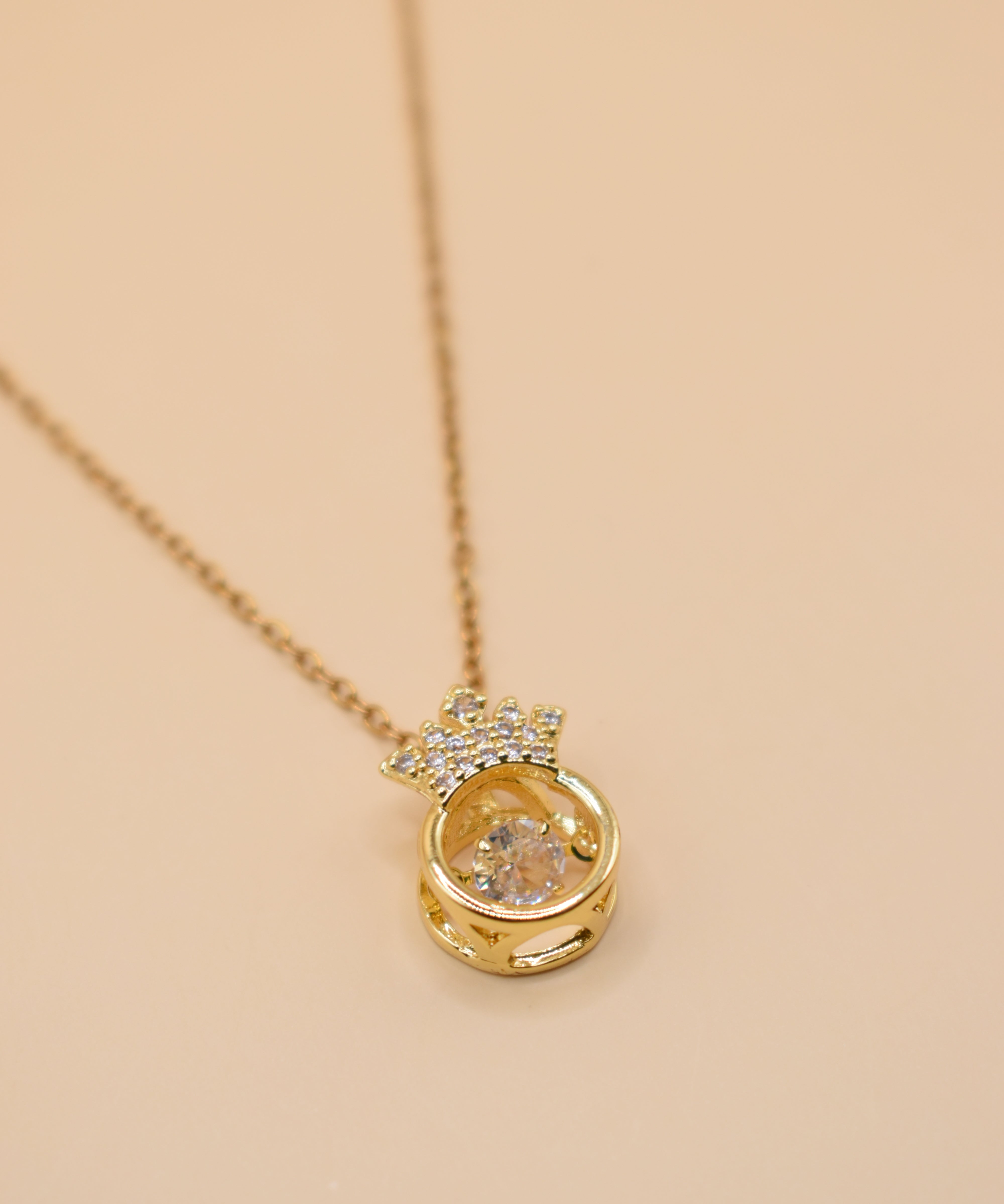 Gold crown necklace with small pendant and thin chain