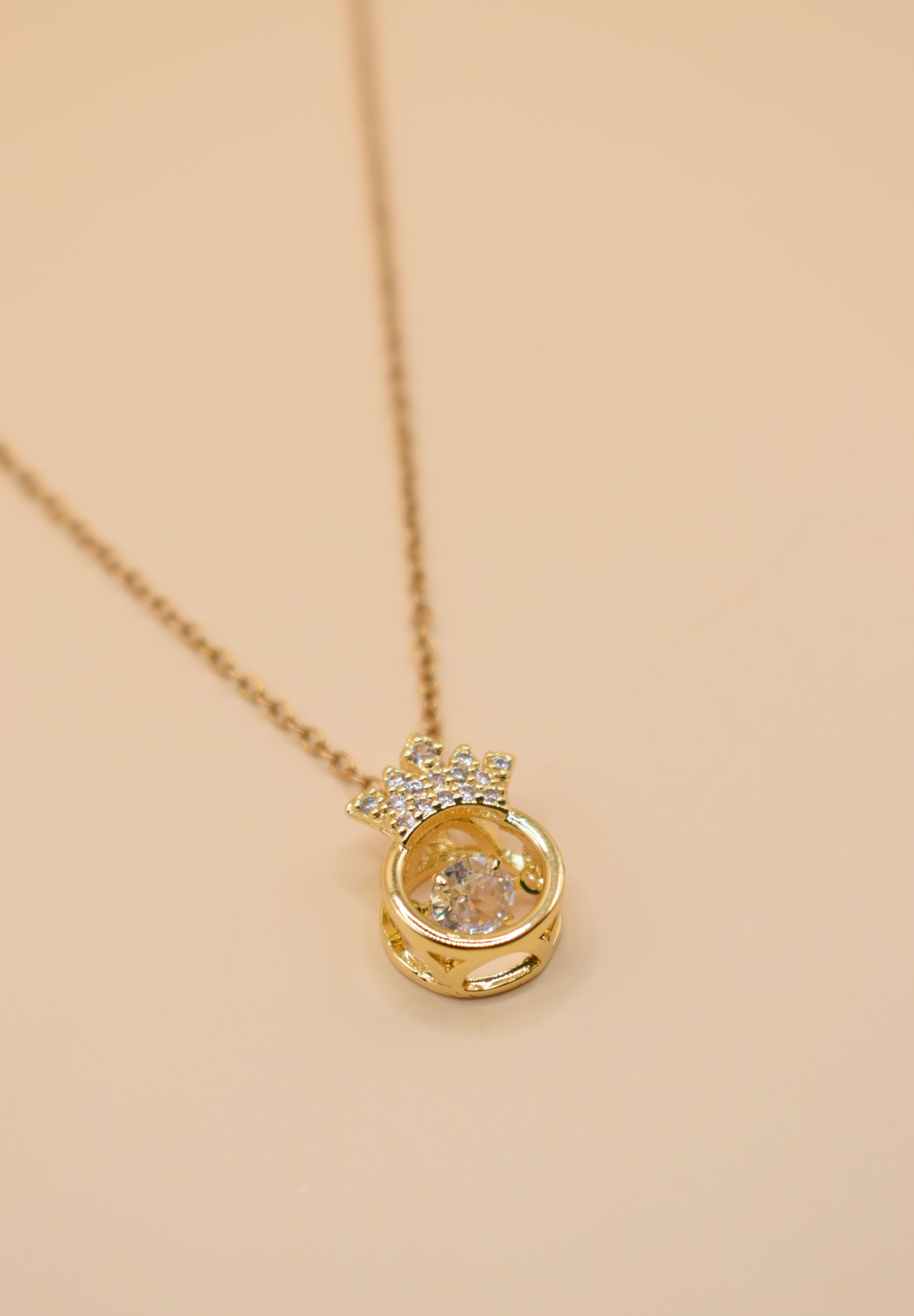 Gold crown necklace with small pendant and thin chain