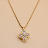 Gold clover pendant necklace with rotating charm