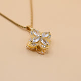 Gold clover pendant necklace with rotating charm
