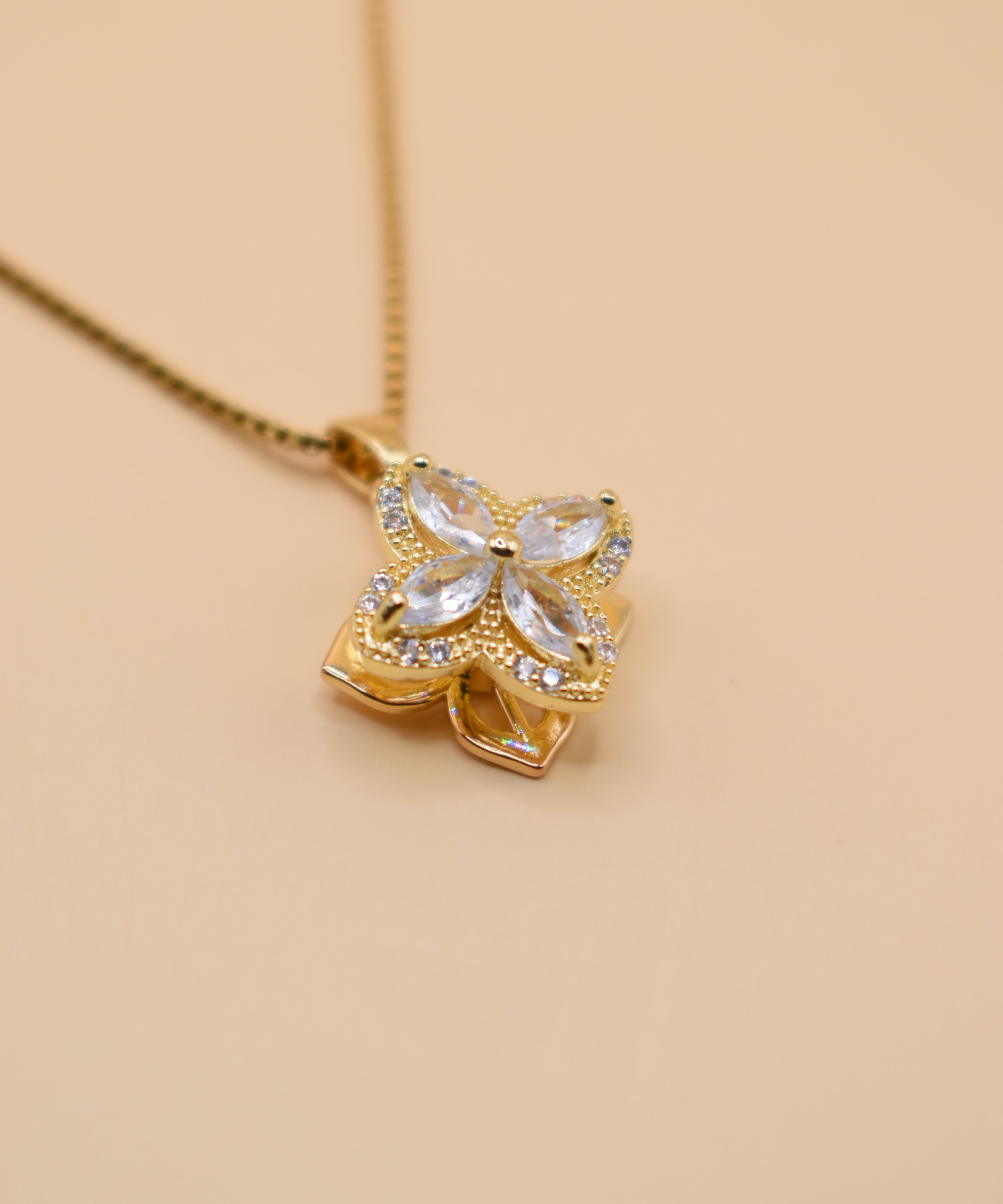 Gold clover pendant necklace with rotating charm