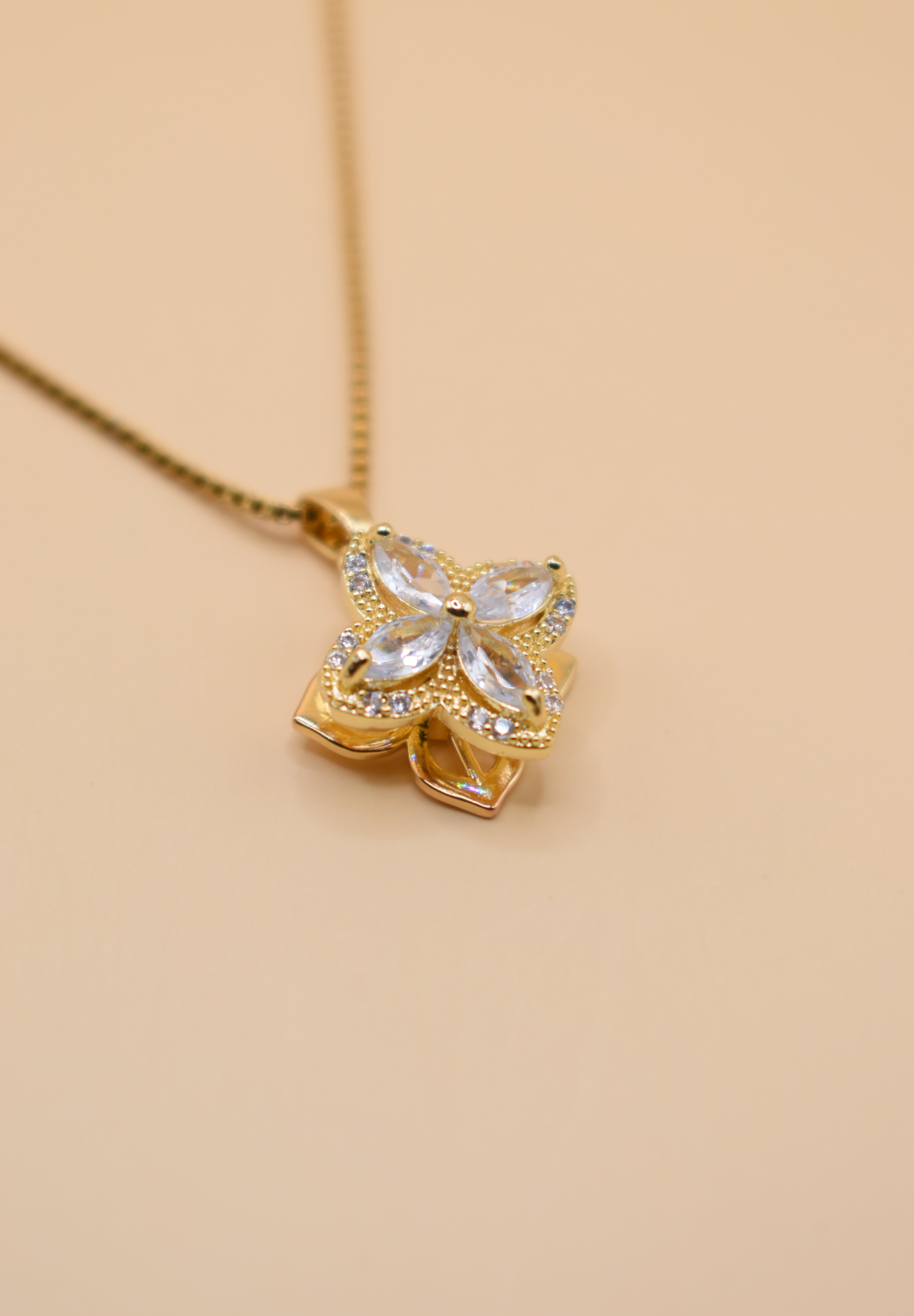 Gold clover pendant necklace with rotating charm