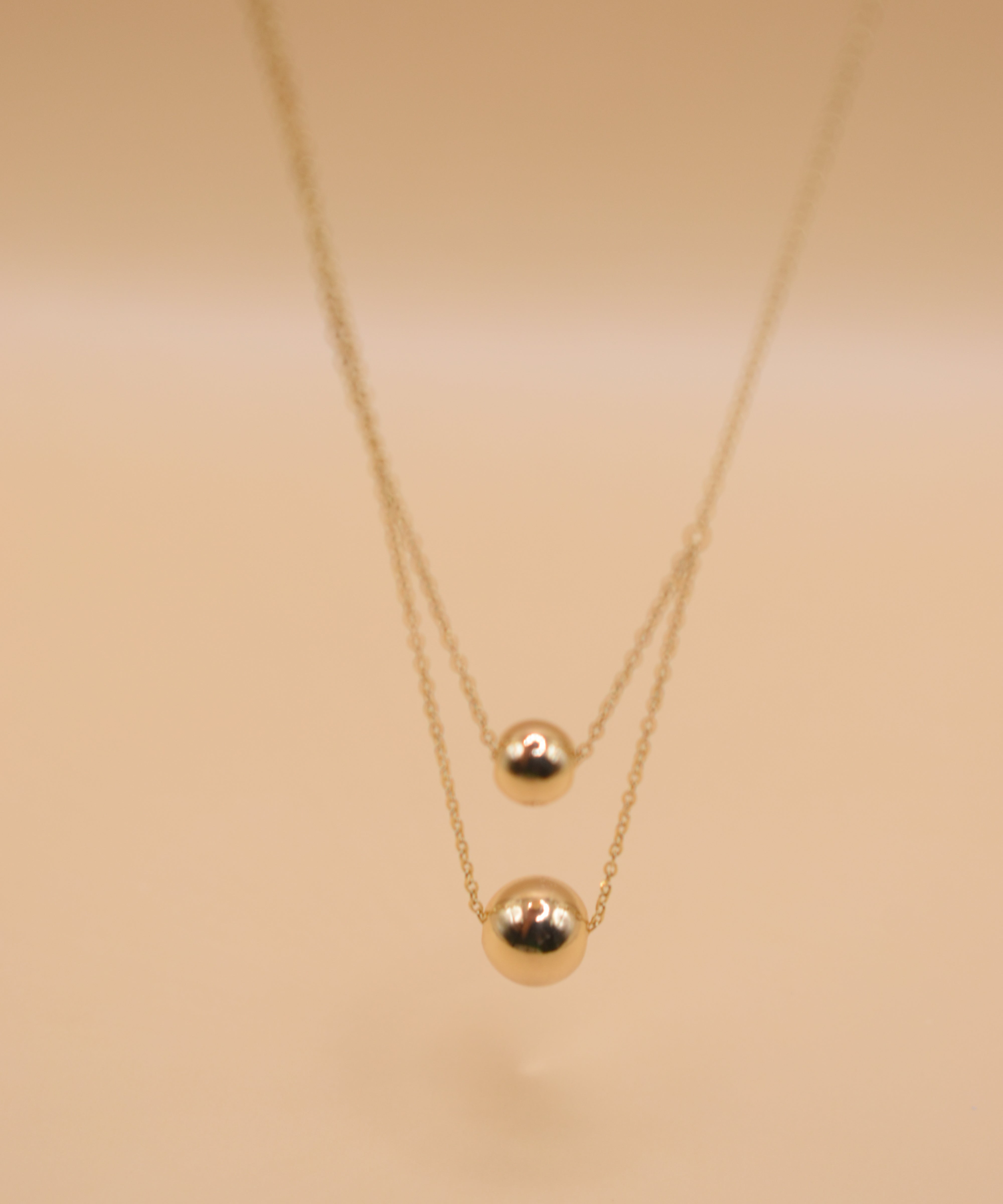 Gold double ball layered necklace with dainty chain