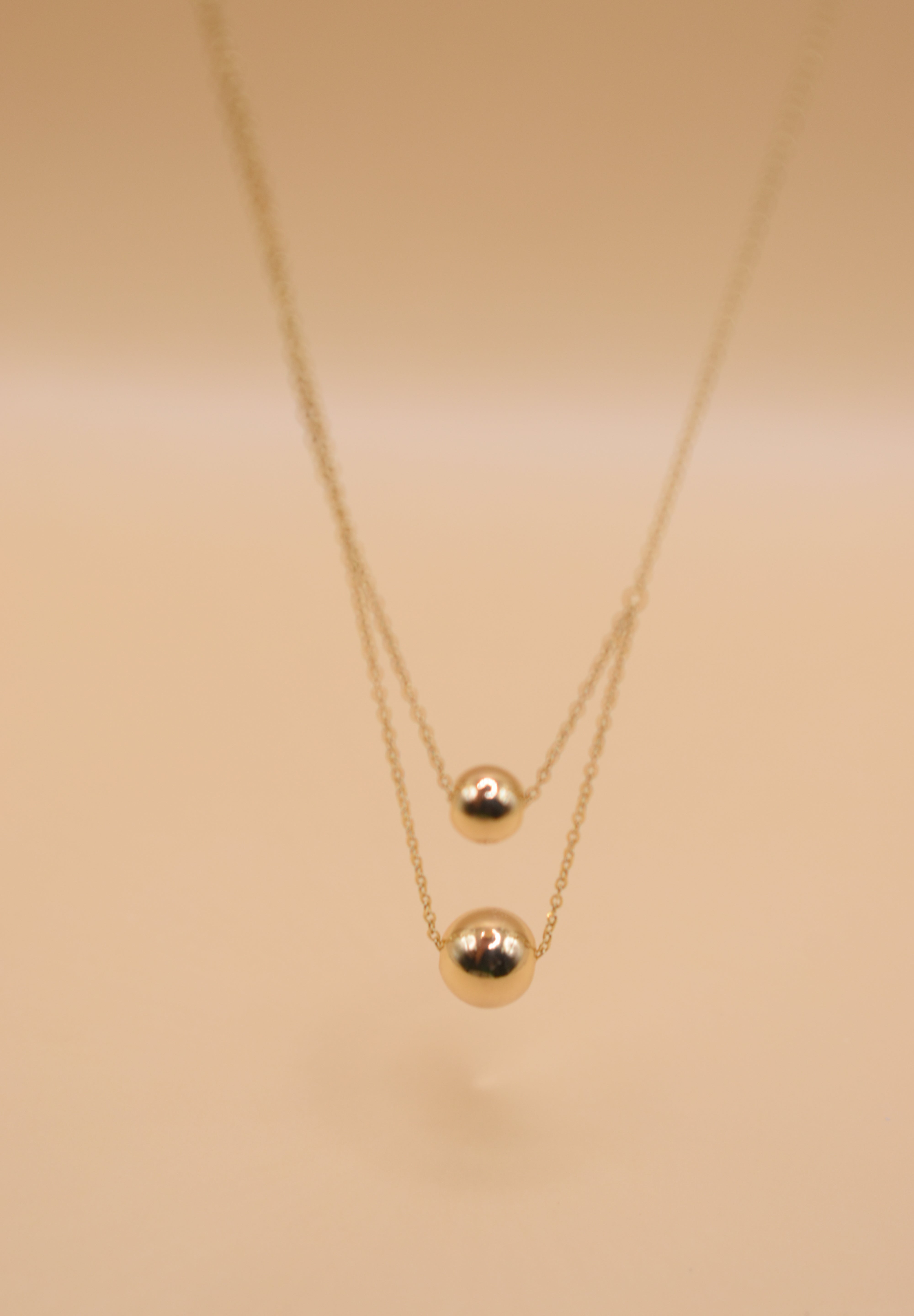 Gold double ball layered necklace with dainty chain